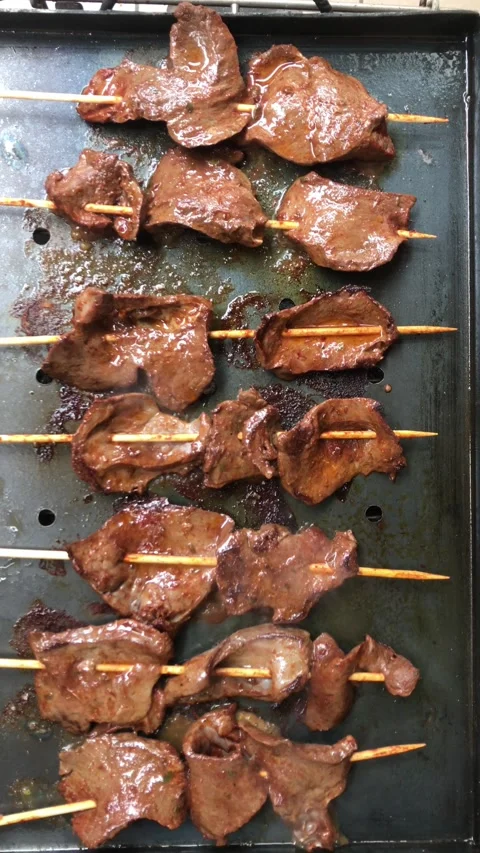 Image from above of grilled anticuchos being fried. Stock Footage 286280633