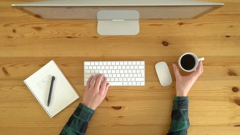 Image from above of man drinking coffee and writing at notebook during the day. Stock Footage 128772469