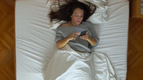 Image from above of woman using the cell phone during the night. Video stock 119722517