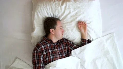 Image from above of your man having problems to sleep during the morning. Stock Footage 132183243