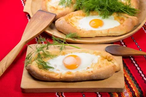 An image of an Ajarian khachapuri on table with raw egg close up Stock Photos