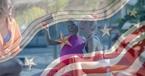 Image of american flag elements over happy diverse female friends taking selfies Fotos Stock