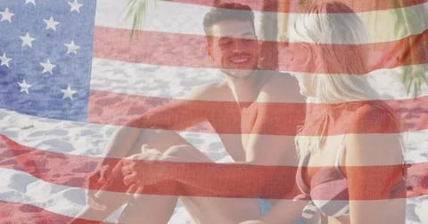 Image of american flag waving over smiling couple in love on beach Ilustração Stock