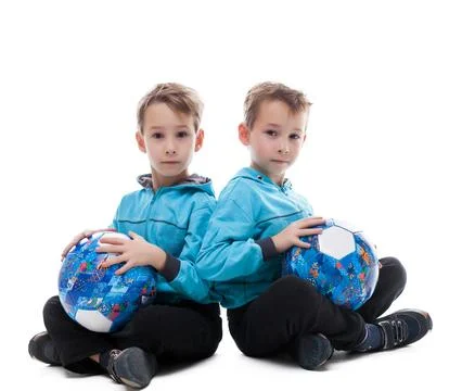 Image of amusing twin brothers posing with balls Stock Photos