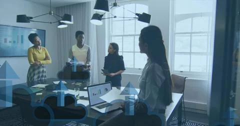 Image of arrow on clouds over diverse female coworkers discussing reports in Stock Photos