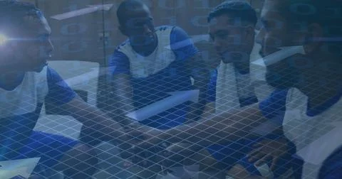 Image of arrows and binary coding over football players stacking hands in Foto stock