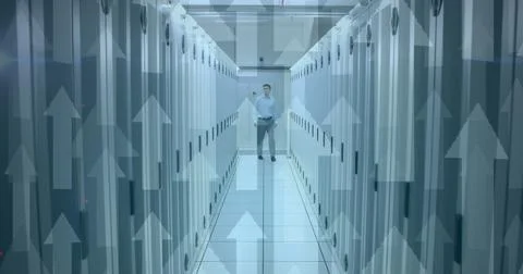 Image of arrows pointing up with man in tech room with computer servers Stock Photos