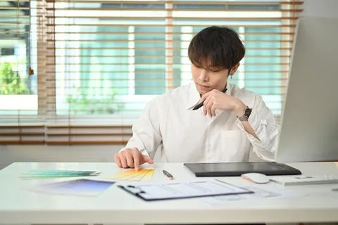 Image of asian man designer developing a new app design and user interface at Foto stock