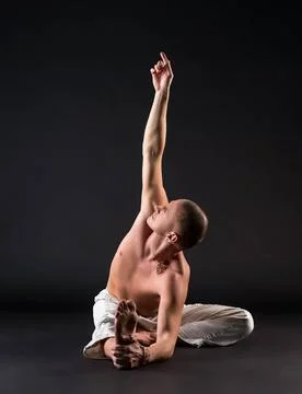 Image of bare-chested man doing yoga in studio Image of bare-chested man d... Stock Photos