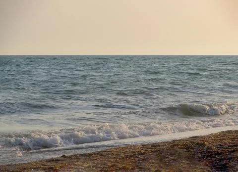 On image: Beach on a Sunny summer day during sunset. Landscape with sea sunse Stock Photos