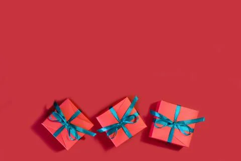 Image of beautiful red gift boxes on a red background. Stock Photos