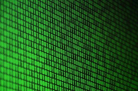 An image of a binary code made up of a set of green digits on a black backgro Stock Photos