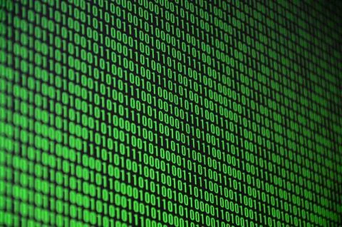 An image of a binary code made up of a set of green digits on a black backgro Stock Photos