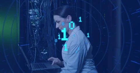 Image of binary code over caucasian woman checking servers Photos