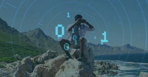 Image of binary codes, circles over african american man looking through Stock Photos