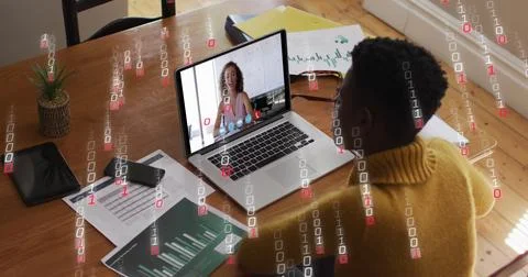 Image of binary coding over african american woman having a image call on laptop Foto stock