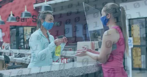 Image of binary coding over caucasian female worker with face mask disinfec.. 스톡 사진