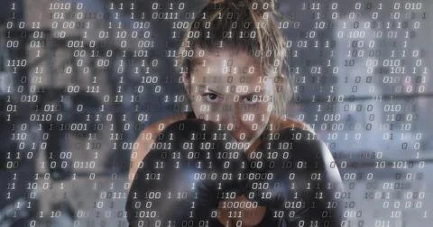 Image of binary coding over caucasian woman wearing boxing gloves at gym Foto stock