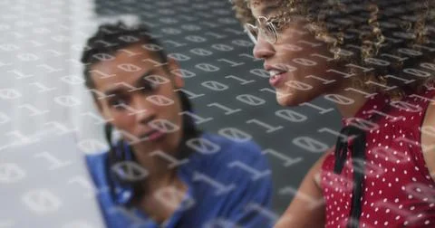 Image of binary coding over diverse business people using laptop Foto stock