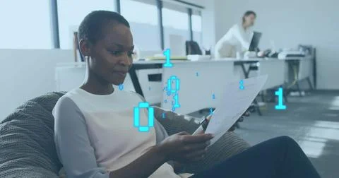 Image of binary data processing over african american woman talking on phone in Stock Photos