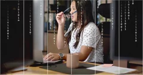 Image of binary data processing over tired biracial businesswoman using computer Stock Photos