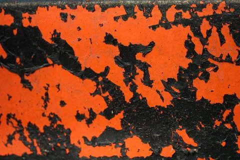 The image is of a black and red surface with a lot of paint on it Stock Photos