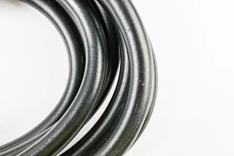 Image of a black coiled cable bundle, resembling a roll or spool New, smooth  Stock Photos