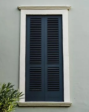 Image of a black window with a white frame, set against a grey wall Stock-Fotos