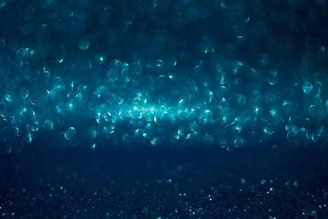 The image is a blue background with many small, round, and blurry dots Stock Photos