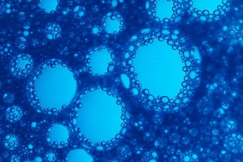 The image is of a blue liquid with many small bubbles Stock Photos