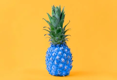 Image of blue pineapple on yellow background Stock Photos