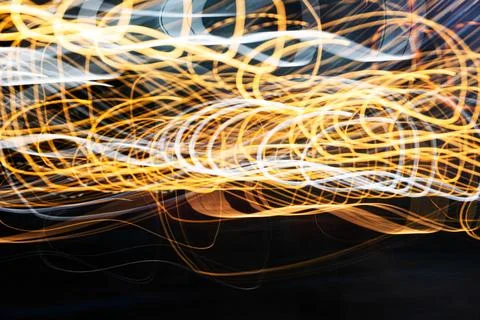 The image is a blurry, wavy line of light that appears to be yellow and white Stock Photos