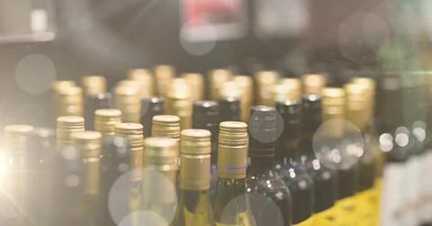 Image of bokeh over wine bottles at shop Ilustração Stock