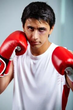 Image of a boxer in red gloves ready to attack his rival Stock Photos