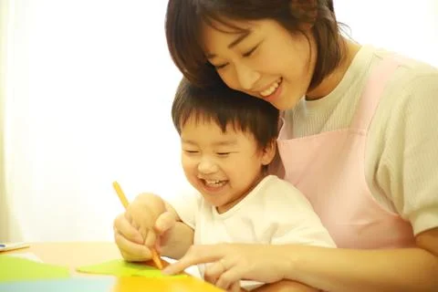 Image of a boy working and a nursery teacher Stock Photos