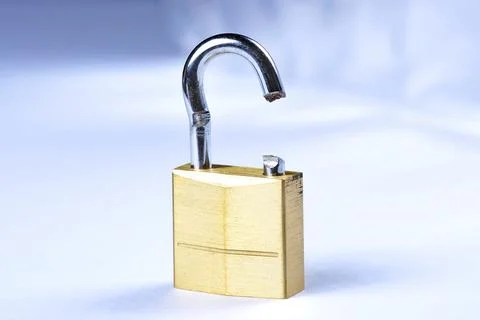 Image of a broken gold lock with a blue background 写真素材