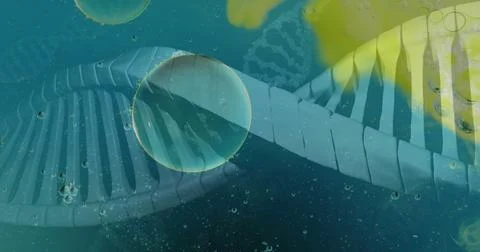 Image of bubbles over dna strands on blue background Stock Photos