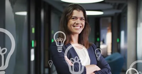 Image of bulb icons floating over caucasian businesswoman smiling on office Stock Photos