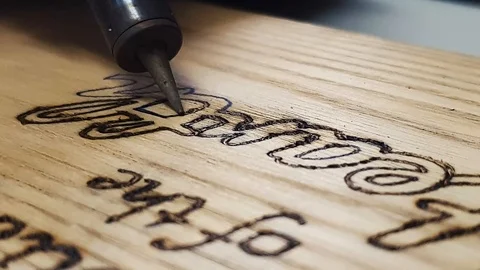 An image burned in the wooden plot. Writing text on the wood with a Vídeos de archivo 121169774