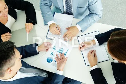 Image of business group discussing business documents at meeting Stock Photos