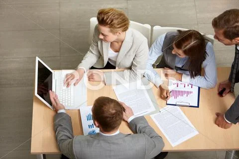 Image of business partners sitting at table and planning work Stock Photos
