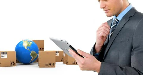 Image of businessman using tablet with stacks of boxes and globe on white 写真素材