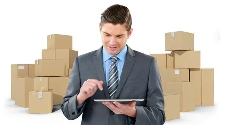 Image of businessman using tablet with stacks of boxes on white background Stock Photos