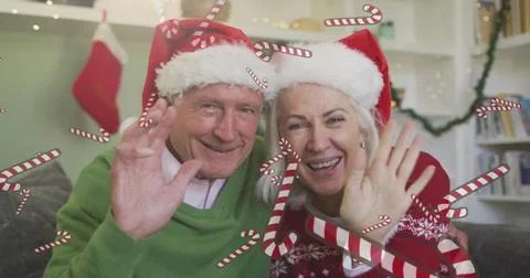 Image of candy canes over senior caucasian couple having image call with Ilustração Stock