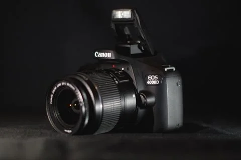An image of a canon camera with flash light on it Stock Photos