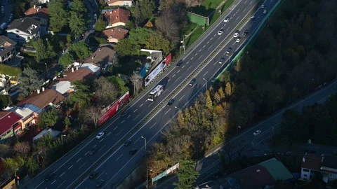 This image captures an aerial view of a busy urban highway Stock Footage 317909894