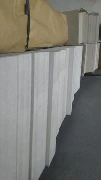 The image captures neat rows of clean white paper stock and brown kraft paper Stock Photos