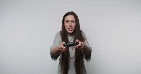 Image captures a young woman expressing discomfort on white background Stock Footage 314336832