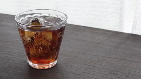 Image of carbonated drinks on a table by the window Stock Footage 285280680