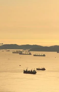 Image of cargo ship at twilight time. Stock Photos
